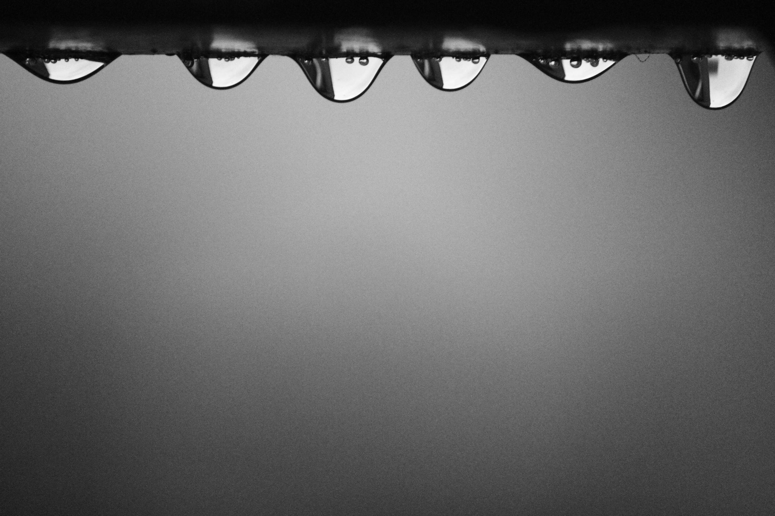 Water droplets hanging down from a flat surface